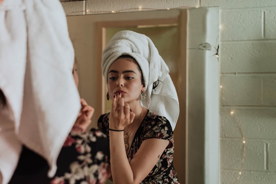 Someone finishing their makeup in front of a mirror